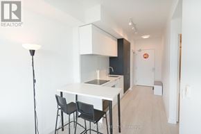 Toronto (Yonge-Eglinton) condo for rent - A modern kitchen with a dining table and chairs.