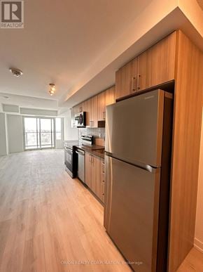Pickering (Bay Ridges) condo for rent - A kitchen with a refrigerator, microwave, and oven.