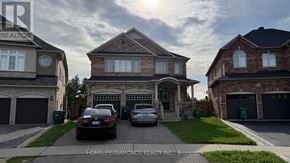 Brampton (Bram East) apartment for rent - A house with a car parked in front of it.