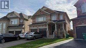 Brampton (Bram East) apartment for rent - A row of houses with cars parked in front.