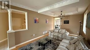 Brampton (Bram East) apartment for rent - A living room with a couch, coffee table, and a chandelier.