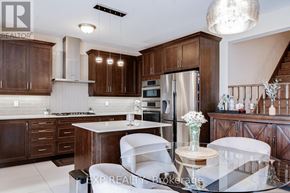 Brampton (Northwest Brampton) apartment for rent - A modern kitchen with dark wood cabinets and white countertops.