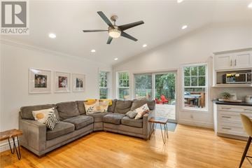 St. John's apartment for rent - A living room with a grey couch and a ceiling fan.