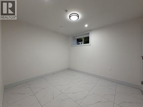 Vancouver apartment for rent - A white room with a window and a tiled floor.