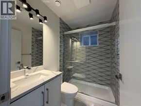 Vancouver apartment for rent - A bathroom with a glass shower stall and a white toilet.