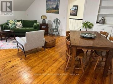 Selwyn apartment for rent - A living room with a green couch and a wooden table.