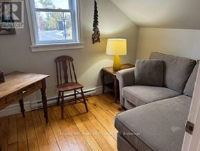 Selwyn apartment for rent - A room with a grey couch, a wooden table and a window.