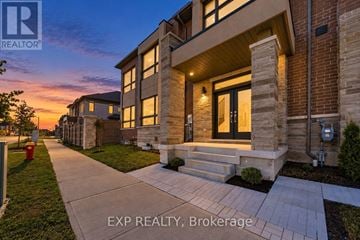 Richmond Hill townhouse for rent - A house with a walkway in front of it at dusk.