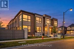 Richmond Hill townhouse for rent - A modern house with a well-lit front yard at dusk.