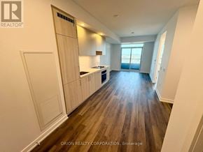 Vaughan (Vaughan Corporate Centre) condo for rent - A spacious kitchen with wooden floors and white walls.
