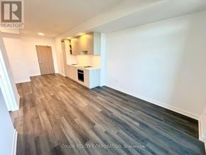 Vaughan (Vaughan Corporate Centre) condo for rent - A room with wood flooring and white walls.