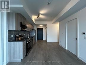 Pickering (Bay Ridges) condo for rent - A kitchen with a microwave, oven, and refrigerator.