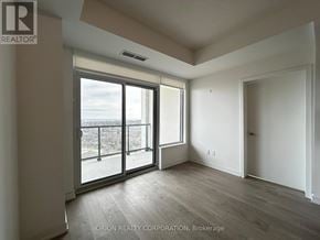 Pickering (Bay Ridges) condo for rent - A room with a sliding glass door leading to a balcony.