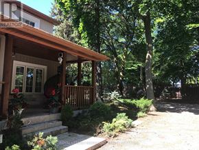 Newmarket (Summerhill Estates) apartment for rent - A house with a porch and a tree in front.