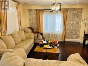 Newmarket (Summerhill Estates) apartment for rent - A living room with a sofa, armchair, coffee table, and a chandelier.