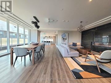 Hamilton (Beasley) condo for rent - A modern living room with a dining table and chairs.