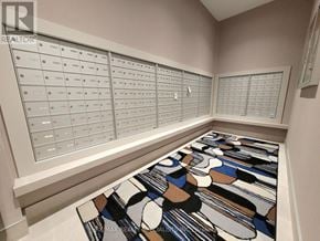 Hamilton (Beasley) condo for rent - A room with a large number of mailboxes on the wall and a colorful rug on the floor.