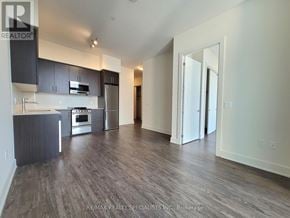 Hamilton (Beasley) condo for rent - A kitchen with dark wood floors and white walls.