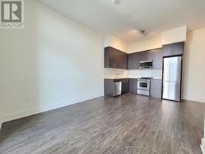 Hamilton (Beasley) condo for rent - A spacious kitchen with stainless steel appliances and wooden flooring.