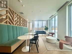 Kitchener condo for rent - A modern living room with a green sofa and wooden accents.