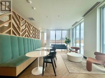 Kitchener condo for rent - A modern living room with a green sofa and wooden accents.