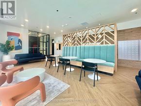 Kitchener condo for rent - A realtor office with a blue couch and a wooden partition.