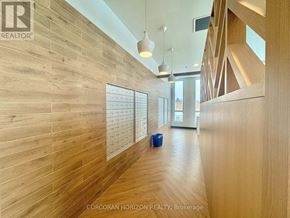 Kitchener condo for rent - A hallway with wood paneling and a brokerage sign.