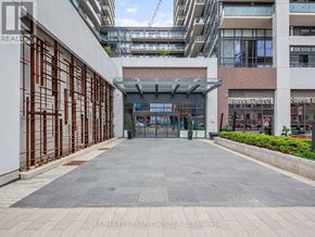 Toronto (Moss Park) condo for rent - A building entrance with a glass door and a metal gate.