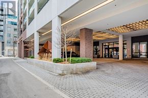 Toronto (Moss Park) condo for rent - A modern building entrance with a planter in front.