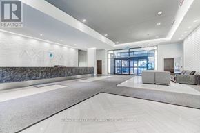 Toronto (Moss Park) condo for rent - A spacious lobby with a marble wall and a large window.