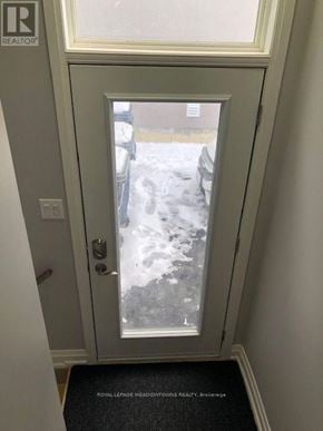 Toronto (Long Branch) apartment for rent - A door with a glass window showing a snowy scene outside.