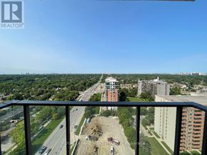 Toronto (Humber Heights) condo for rent - A view from a balcony overlooking a construction site with a highway in the background.