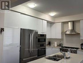 Milton (Walker) apartment for rent - A modern kitchen with stainless steel appliances and white cabinets.