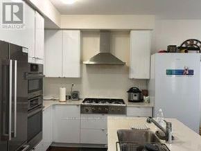 Milton (Walker) apartment for rent - A kitchen with white cabinets and a stainless steel refrigerator.