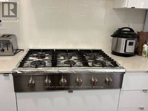 Milton (Walker) apartment for rent - A silver gas stove with six burners is in a kitchen.