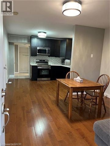 St. Catharines apartment for rent - A kitchen with a wooden table and chairs.