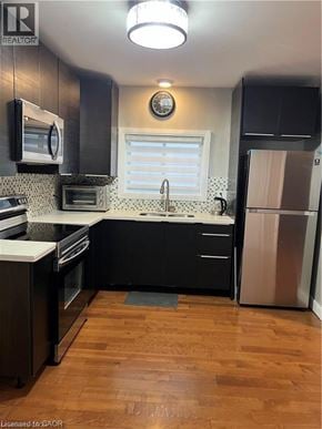 St. Catharines apartment for rent - A kitchen with black cabinets and a wooden floor.