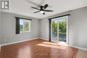Russell condo for rent - A room with a ceiling fan and sliding glass doors leading to a backyard.