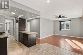 Russell condo for rent - A kitchen with a refrigerator, cabinets, and a countertop is shown in this image.