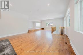 Vaughan (West Woodbridge) apartment for rent - A spacious room with wooden flooring and white walls.