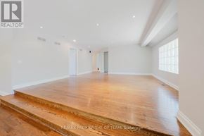 Vaughan (West Woodbridge) apartment for rent - A spacious room with wooden flooring and white walls.