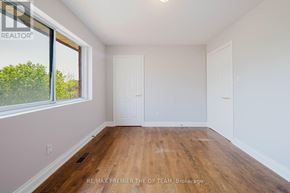 Vaughan (West Woodbridge) apartment for rent - A room with wooden floors and white walls, with a window on the left side.