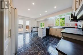 Vaughan (West Woodbridge) apartment for rent - A kitchen with a black tile floor and white walls.