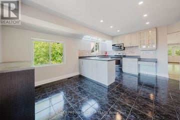 Vaughan (West Woodbridge) apartment for rent - A kitchen with black tiles on the floor and a wooden counter top.