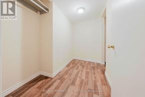 Vaughan (West Woodbridge) apartment for rent - A room with wooden flooring and white walls.