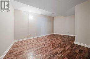 Vaughan (West Woodbridge) apartment for rent - A room with wooden flooring and white walls.