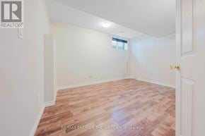 Vaughan (West Woodbridge) apartment for rent - A room with wooden flooring and white walls, with a window and a door visible.