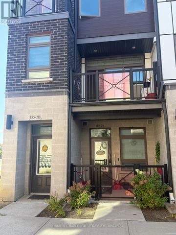 Kitchener townhouse for rent - A building with a balcony and a sign that says "HOMELESS MAPLE LEAF REALTY LTD. BROKERAGE".
