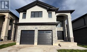 London South (South U) apartment for rent - A modern house with a stone facade and two garage doors.