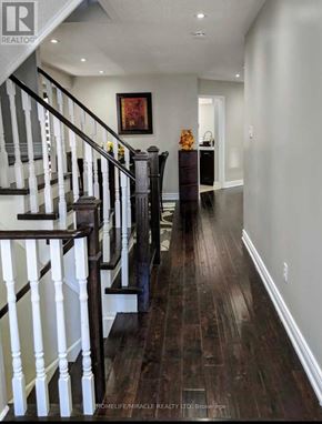 Brampton (Fletcher's Meadow) apartment for rent - A long hallway with a staircase on the left and a doorway on the right.